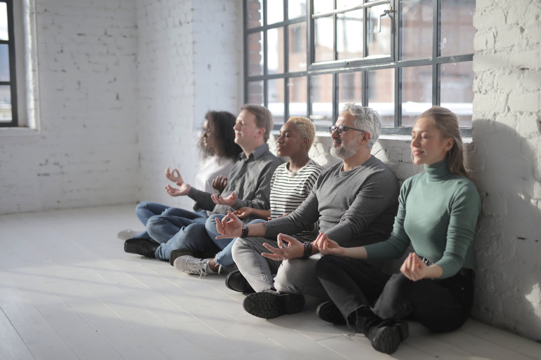 diverse group of colleagues having meditation together