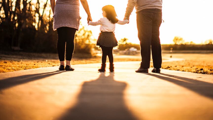 photo of family standing outdoors during golden hour